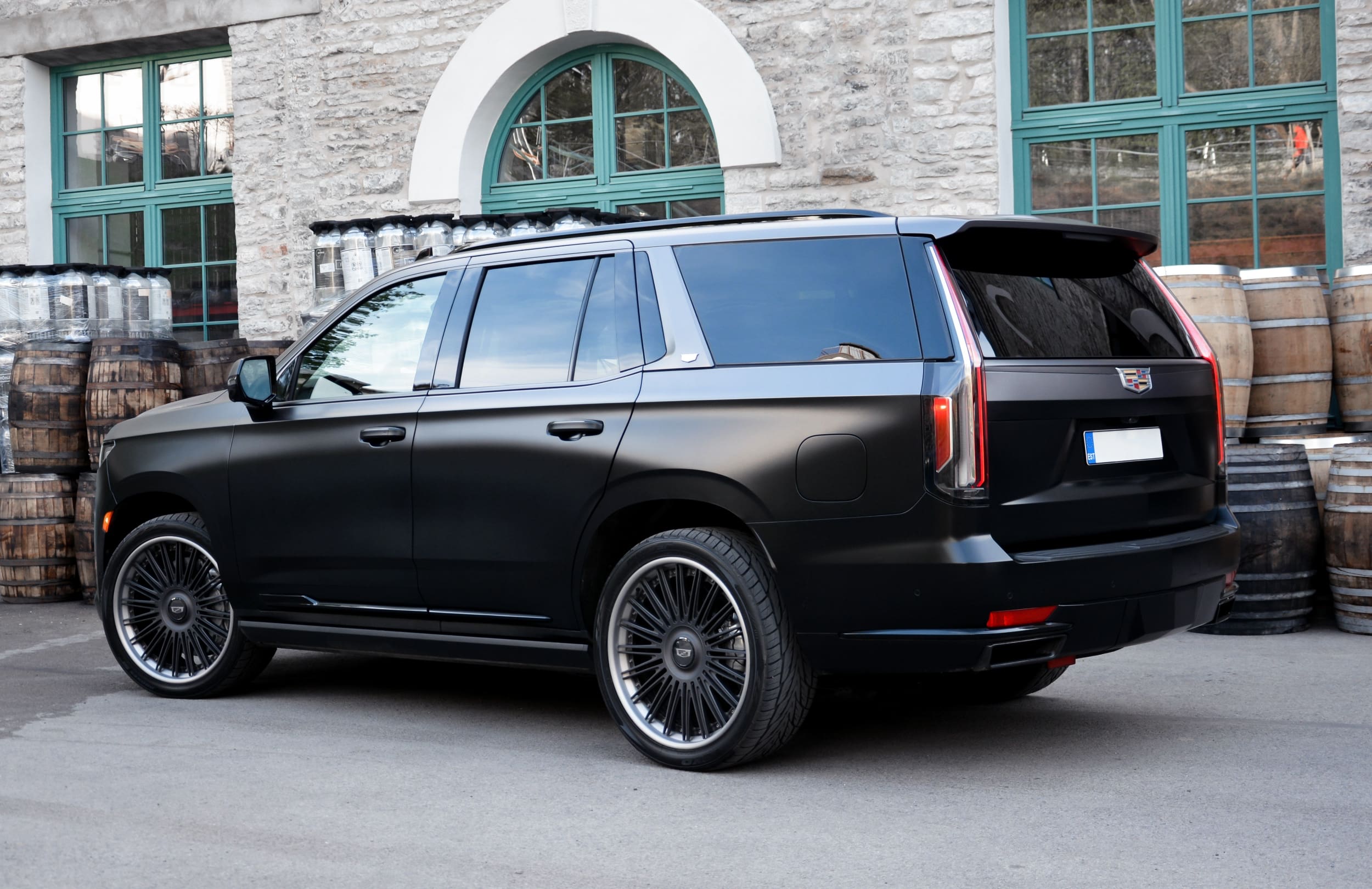 Rear three-quarter view of a two-tone Cadillac Escalade on forged wheels